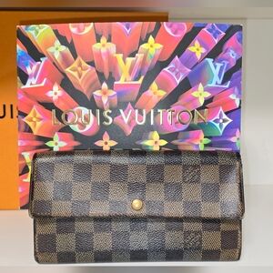 Louis Vuitton wallet in iconic Damier Ebene coated canvas with gold hardware